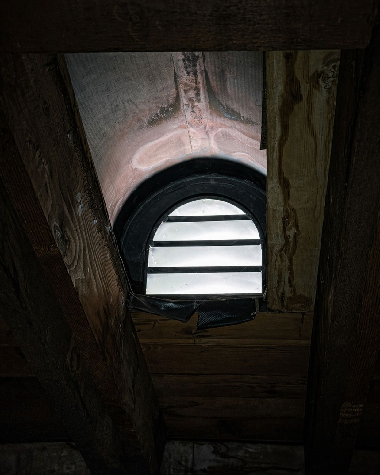 Attic ventilation window showing building infrastructure